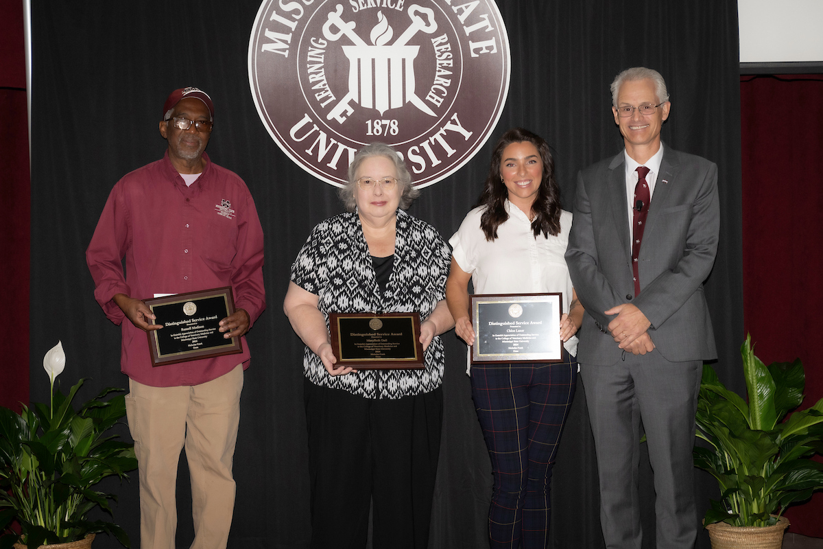 Distinguished staff awardees Russell Madison, Mary Beth Dail, and Chloe Laxer with Dr. Nicholas Frank.