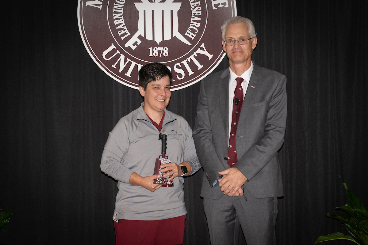 Dr. Nicholas Frank presents the dean’s Pegasus award for service to Dr. Kristie Chavez.