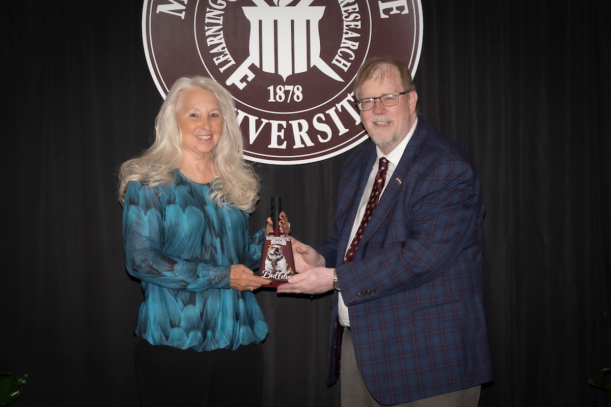 Karen McCord receives the College of Veterinary Medicine Vice President’s Pegasus Award from Dr. Keith Coble.